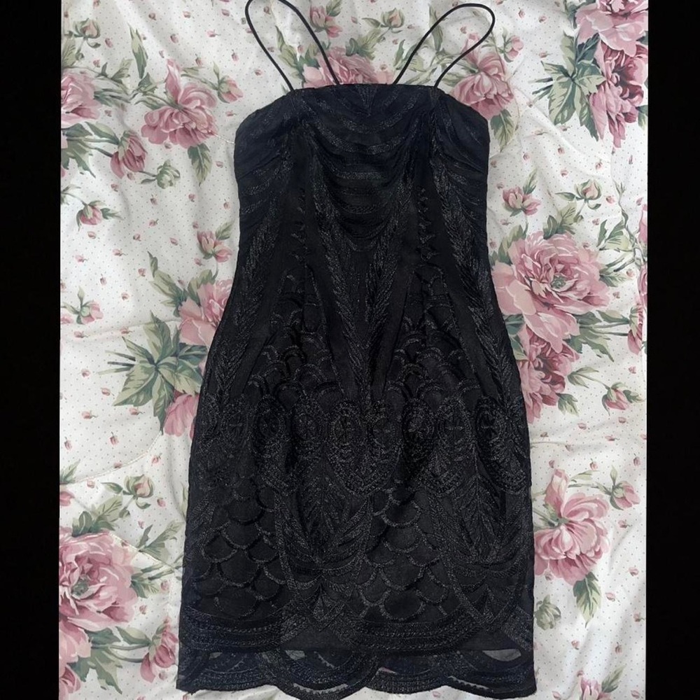 Black fitted mini dress! With a lace like designing/pattern across entire body🥰